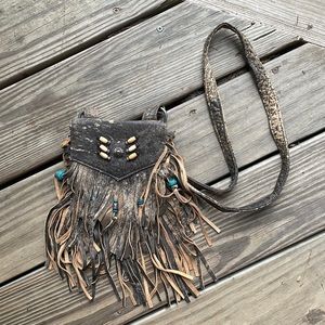 Small leather purse with fringe and beads.